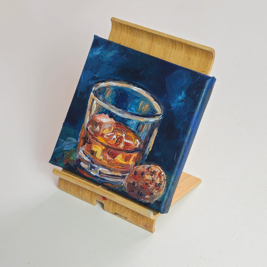 Whiskey Study on a wooden easel against a white background